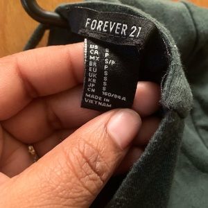 Green crop top with open back.